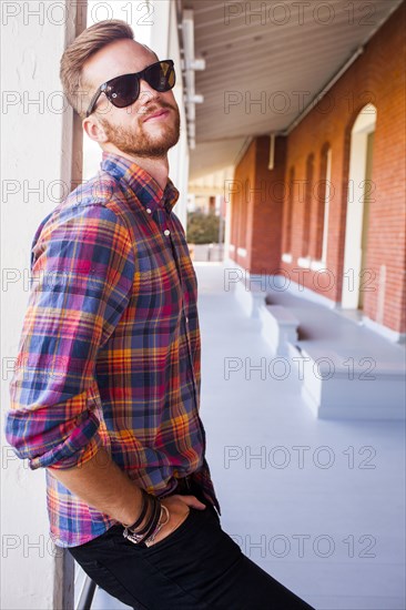 Caucasian man standing under awning