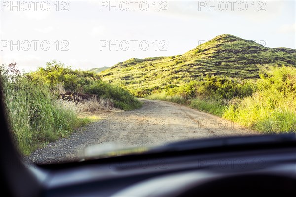 Sandy road viewed through car windshield