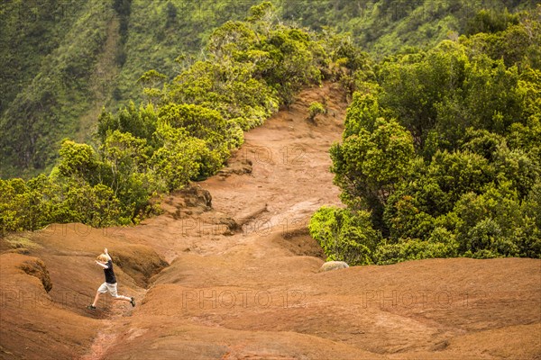 High angle view of man jumping on remote mountainside