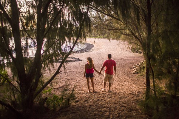 Couple holding hands on beach