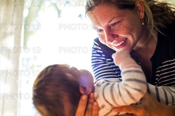 Smiling Caucasian mother cradling baby girl