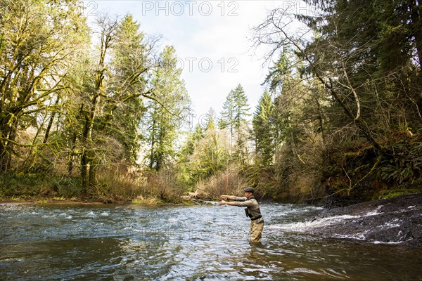 Caucasian fisherman fly-fishing in river