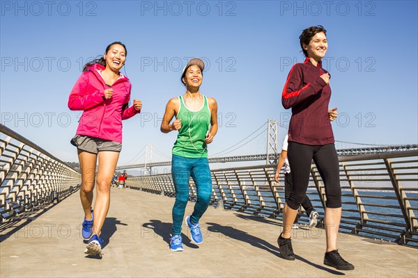 Women running on urban footbridge