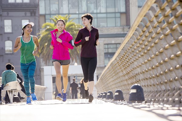 Women running on urban footbridge