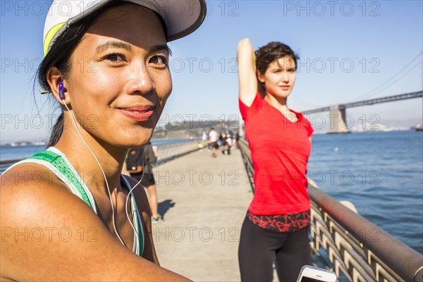Runner stretching on urban footbridge