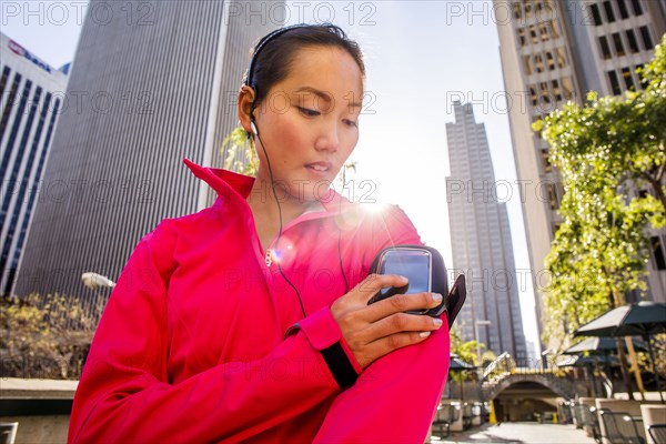 Runner using cell phone in city