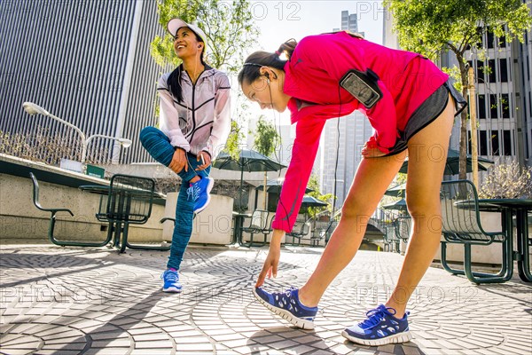 Runners stretching in urban park