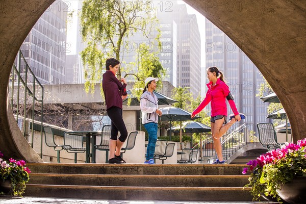 Runners stretching in urban park