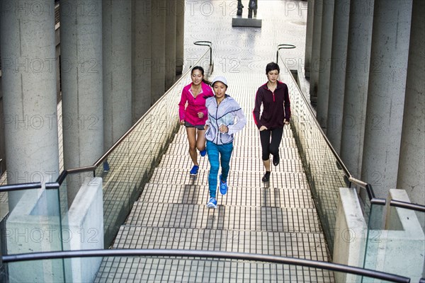 High angle view of women running on staircase