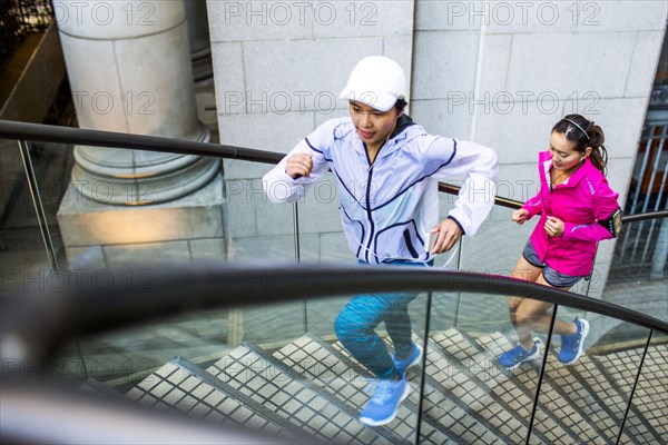 High angle view of women running on staircase