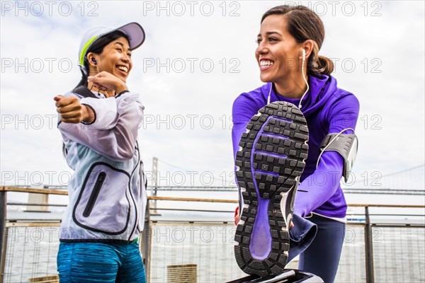 Runners stretching at waterfront