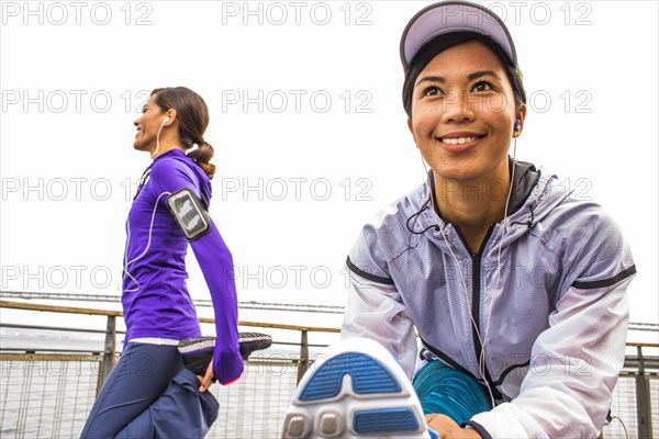 Runners stretching at waterfront