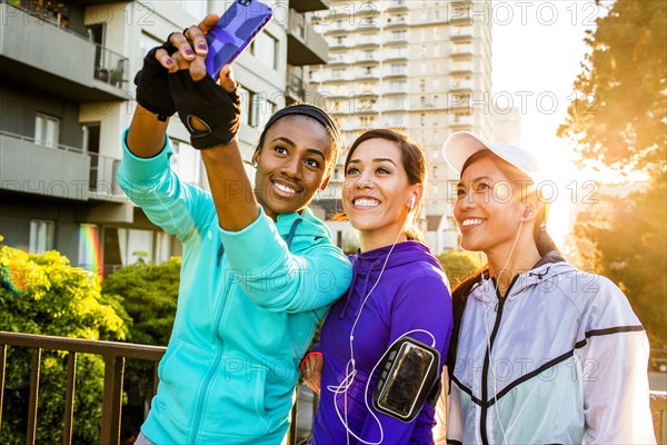 Runners taking selfie in city