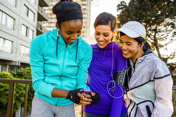 Runners using cell phone in city