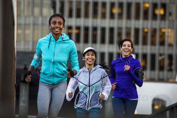 Women running near highrise building