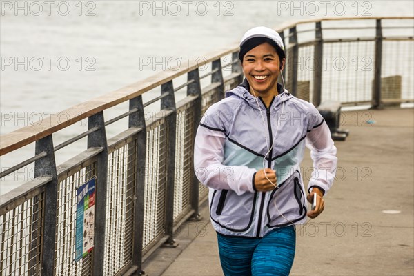 Asian woman running at waterfront