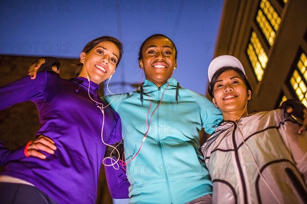 Low angle view of runners smiling at night