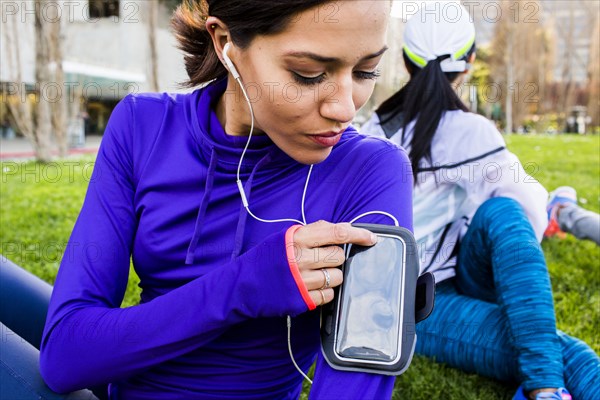 Runner using cell phone in urban park