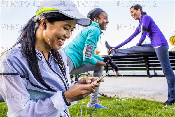 Runner using cell phone in urban park