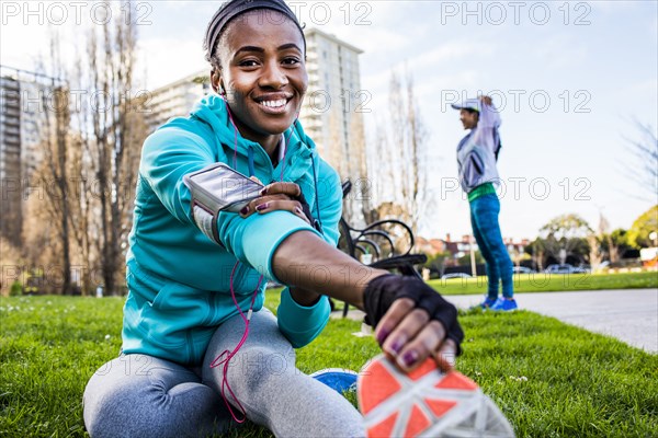 Runner stretching in urban park