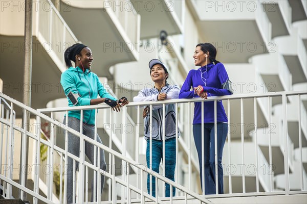 Low angle view of runners standing at railing