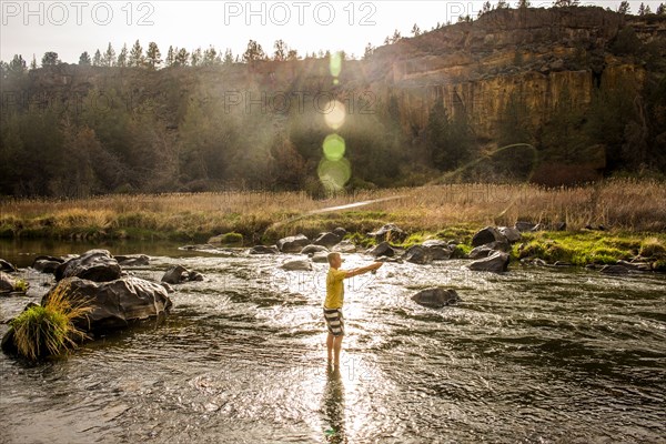 Caucasian man fishing in remote river