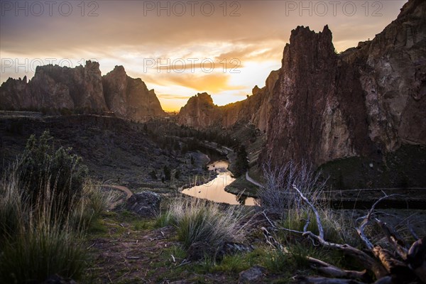 Creek reflecting sunset sky in desert landscape