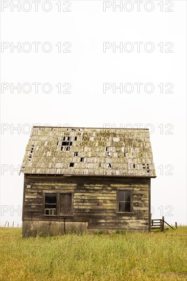 Dilapidated building in rural field