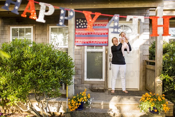 Caucasian mother and baby daughter celebrating 4th of July