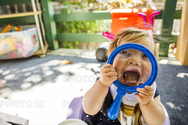 Caucasian baby girl playing on patio