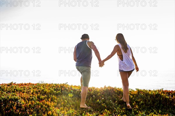 Caucasian couple holding hands outdoors