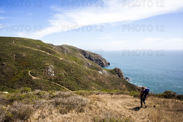 Caucasian mother and child hiking at coast