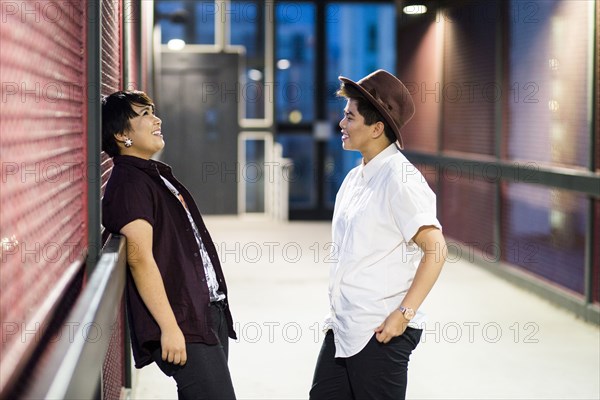 Asian couple talking in hallway