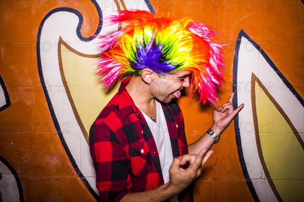 Hispanic man wearing colorful wig