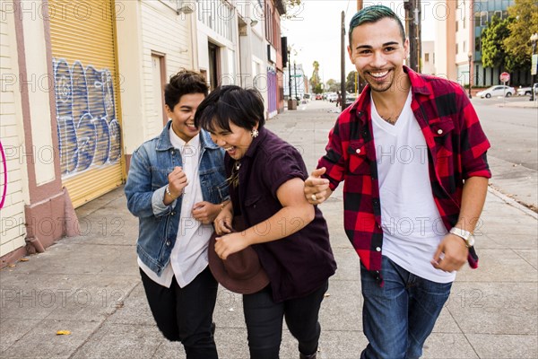 Friends walking on sidewalk