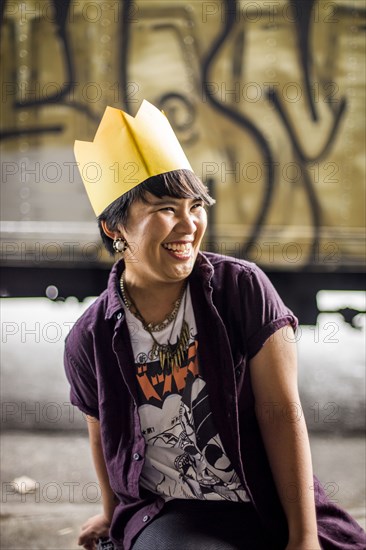 Asian woman wearing paper crown