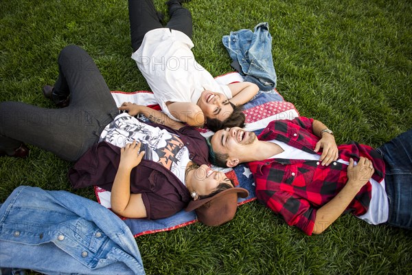 Friends laying in grass