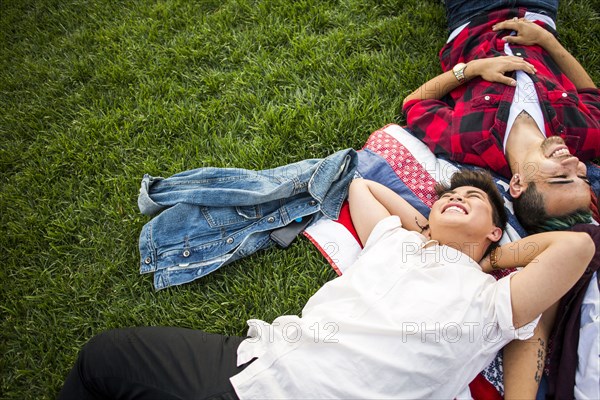 Friends laying in grass