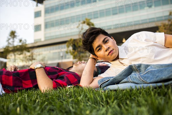 Friends laying in grass