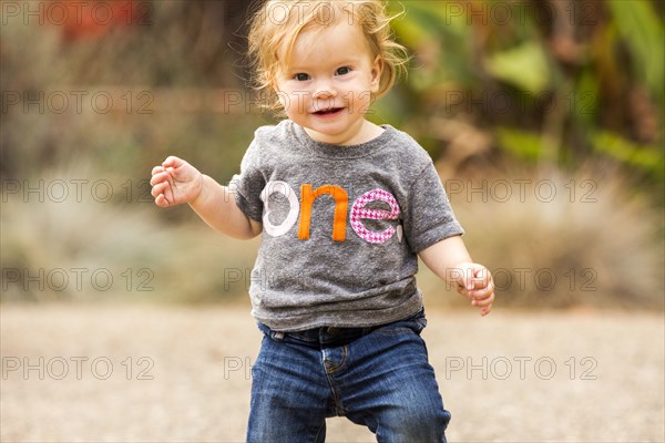 Caucasian baby girl walking outdoors