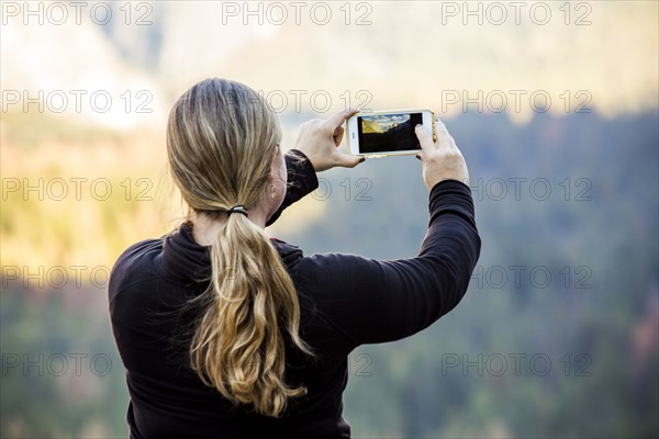 Caucasian woman photographing Yosemite National Park