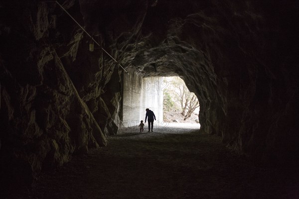 Caucasian mother and daughter walking in cave