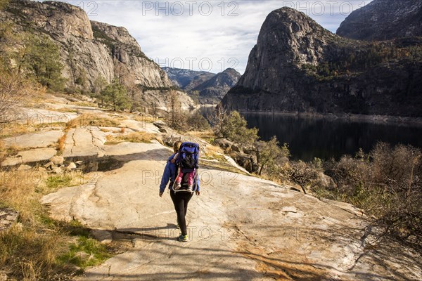 Caucasian mother carrying daughter in Yosemite National Park