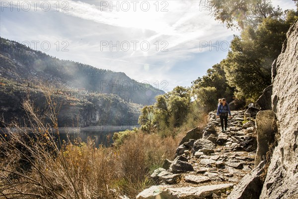 Caucasian mother carrying daughter in Yosemite National Park