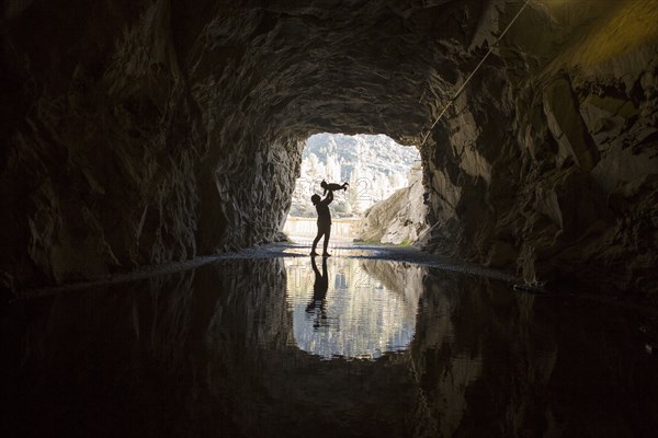 Caucasian mother and daughter playing in cave