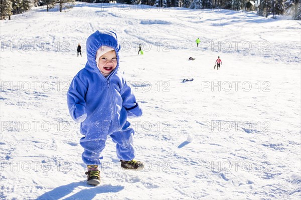 Caucasian girl playing in snow