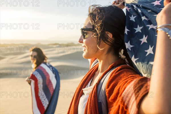 Mixed race women in sand dunes