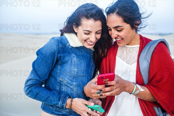 Mixed race women using cell phones