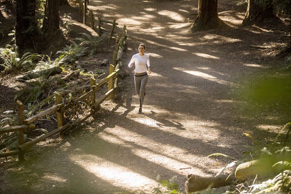 Woman running on forest path