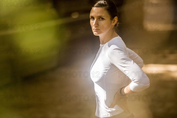 Serious woman looking at camera outdoors